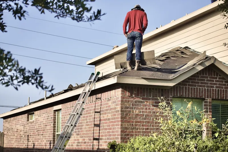 Professional roofer working on a residential roof in Rancho Carlsbad